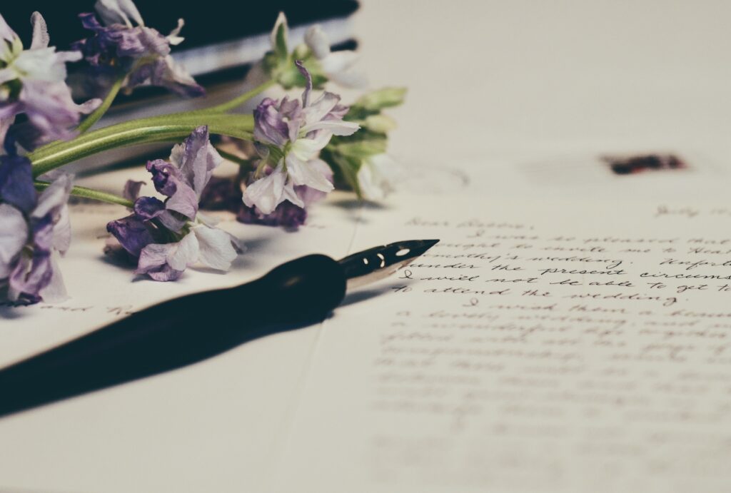 lavendar flowers with fountain pen used for wrting wills
