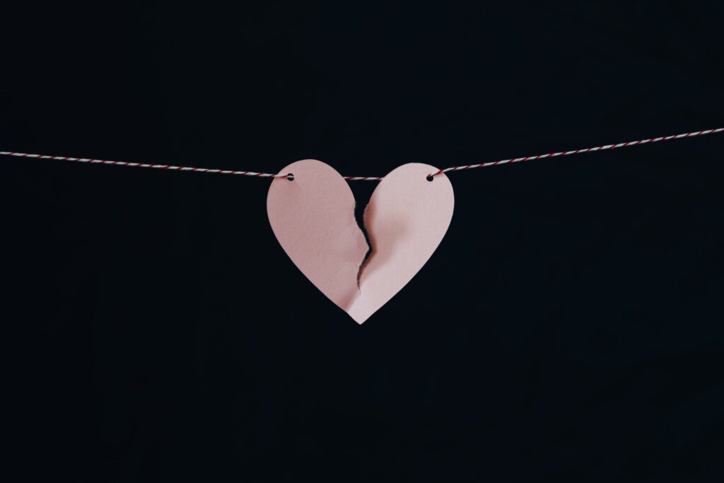 broken heart cutout hanging from ribbon