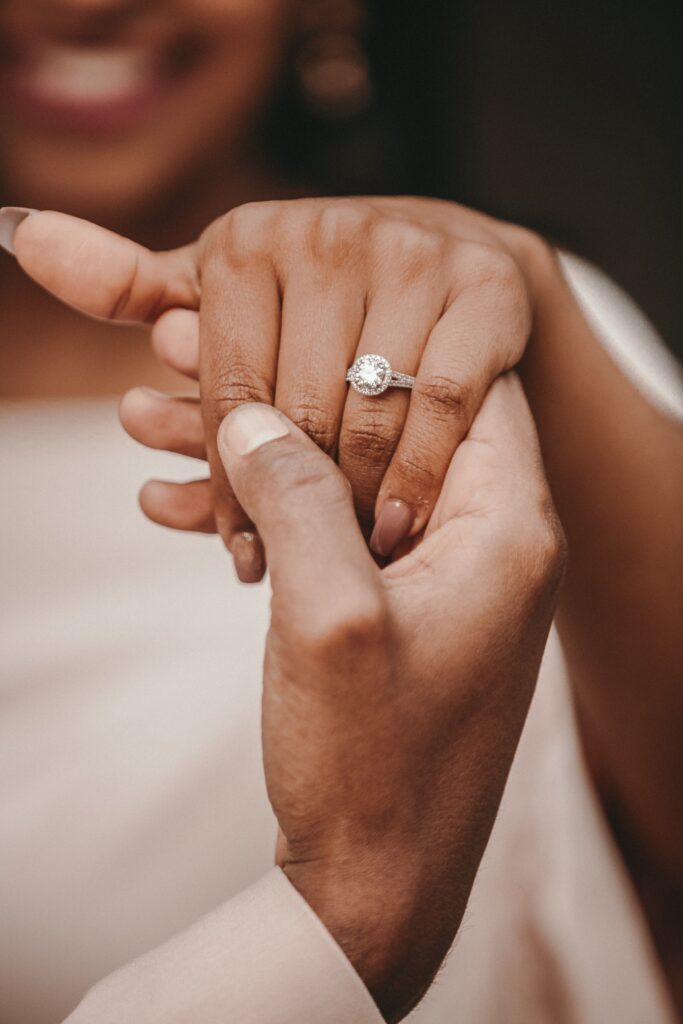 newly engaged woman showing her engagement ring to a friend