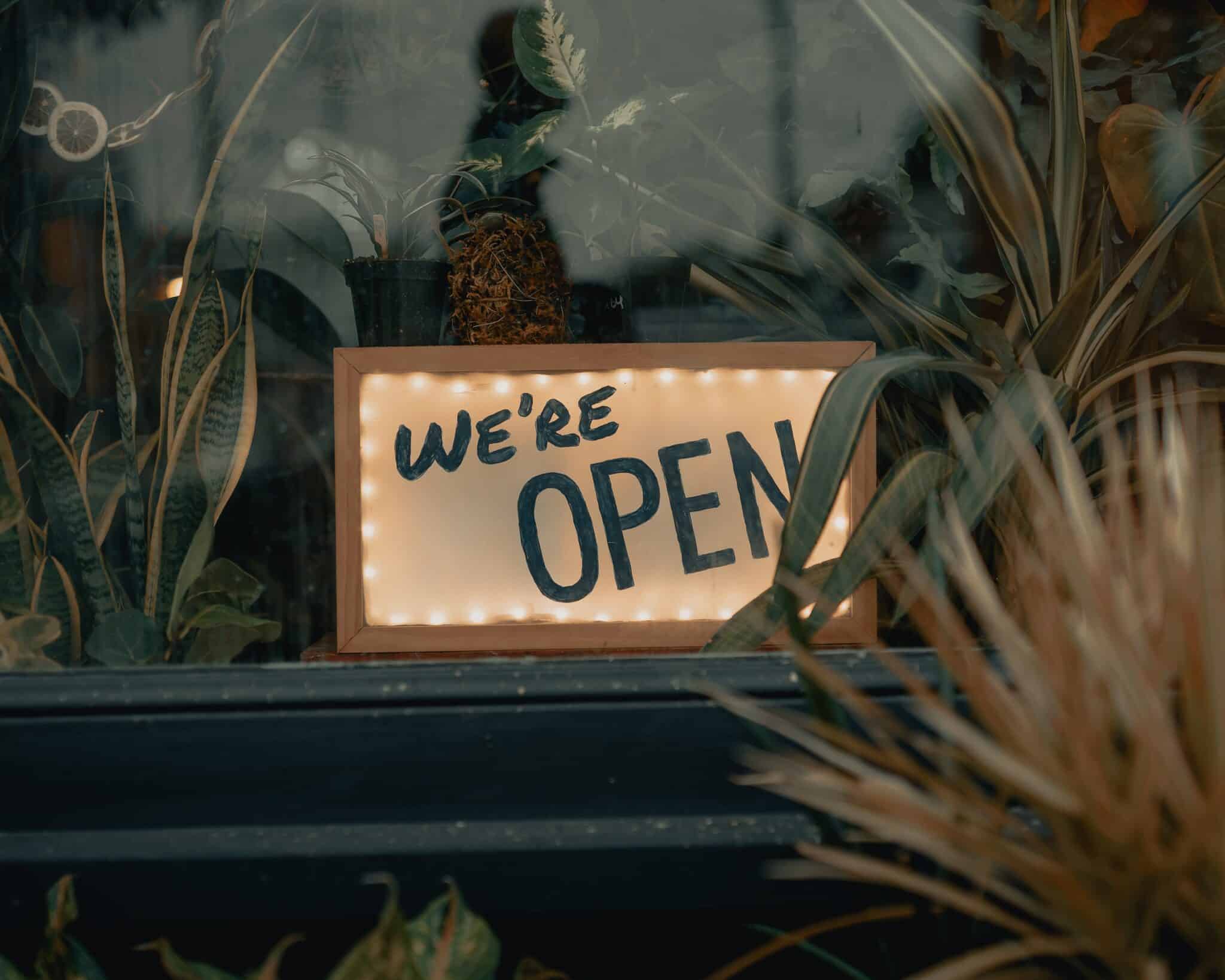 illuminated 'we're open sign' in shop window