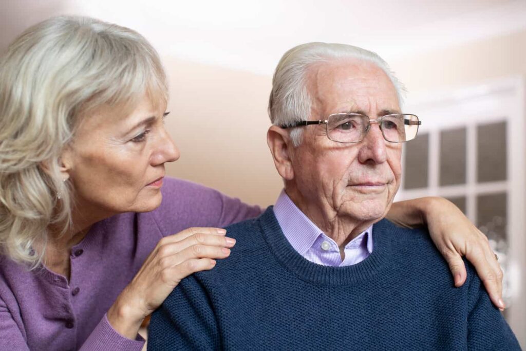 a confused senior man comfoted by his partner