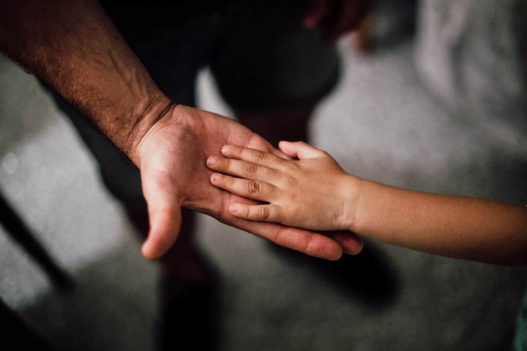 daughter holding her fathers hand