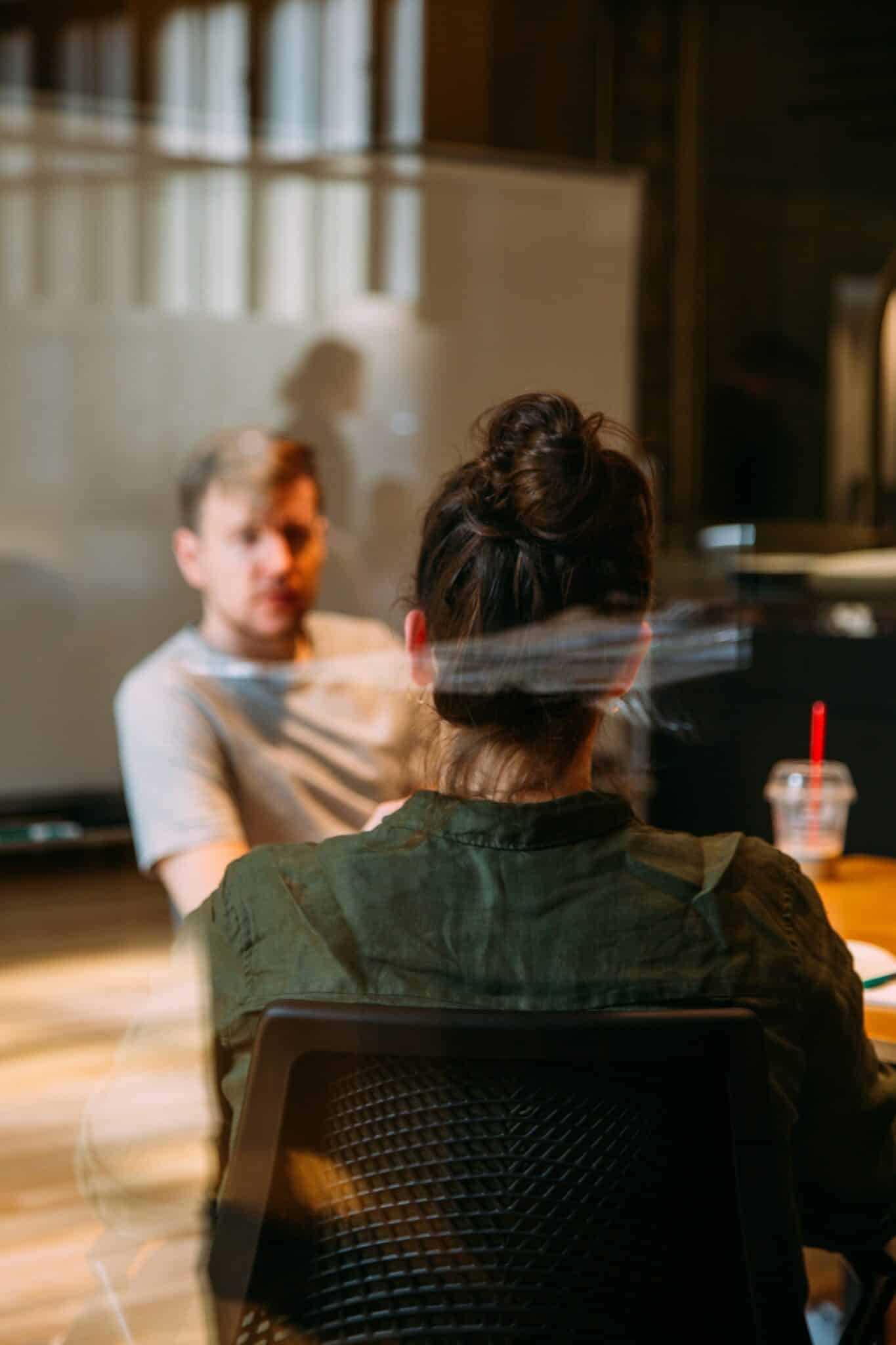 a couple in glass office negotiating terms