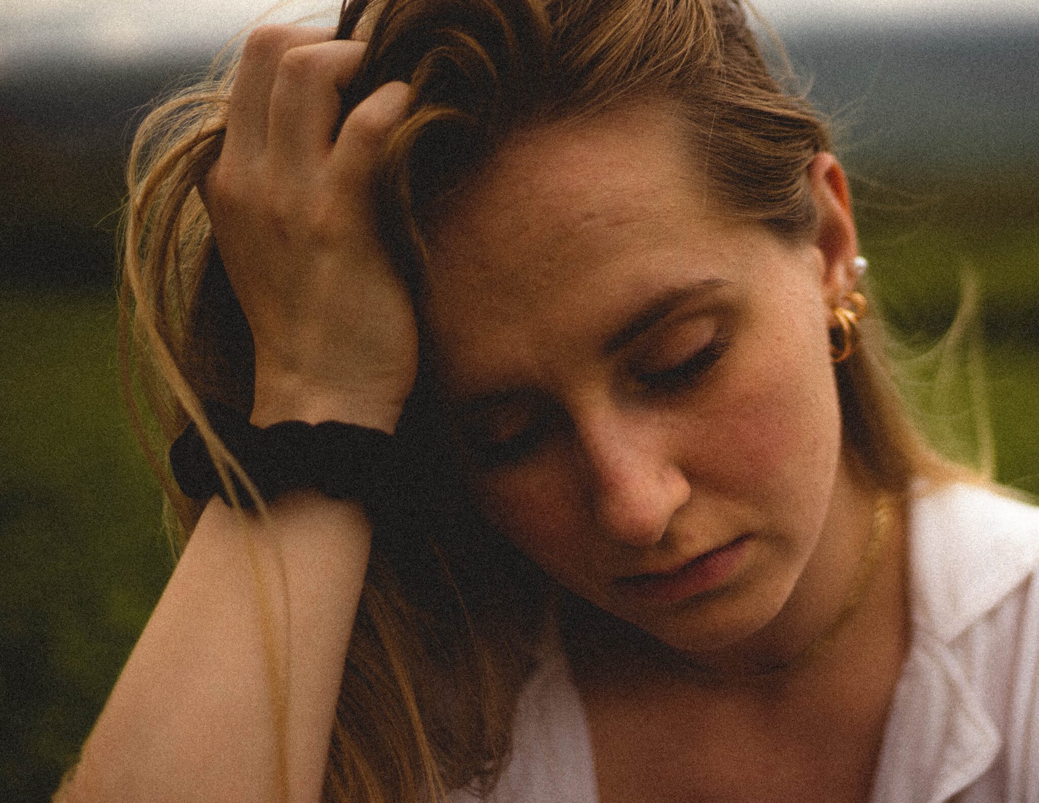 an upset younger woman with her head in her hands