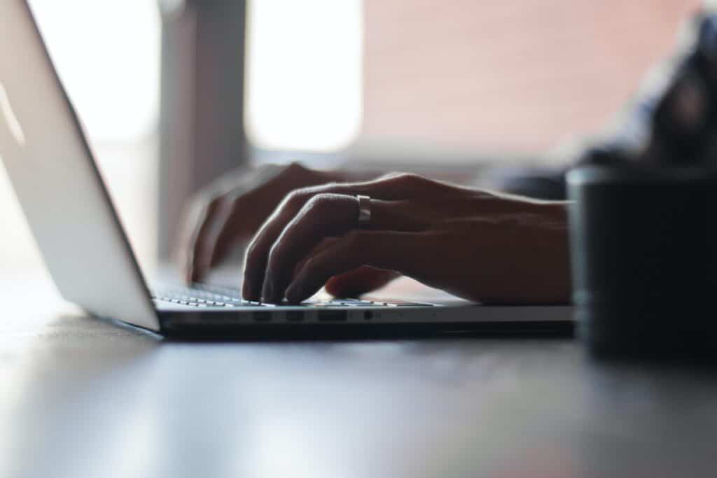 married man typing on computer