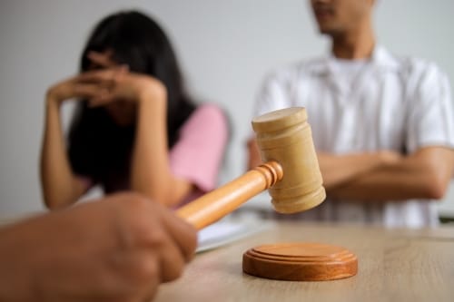 Judge Gavel and Justice Lawyer Deciding on Marriage Divorce Between Married Couple.